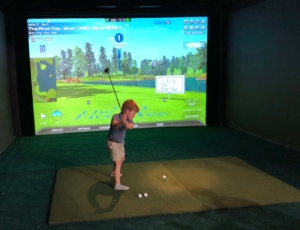 A young boy playing virtual golf