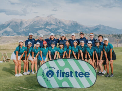 Group of First Tee participants posed in front of a mountain at the 2022 First Tee Leadership Summit.