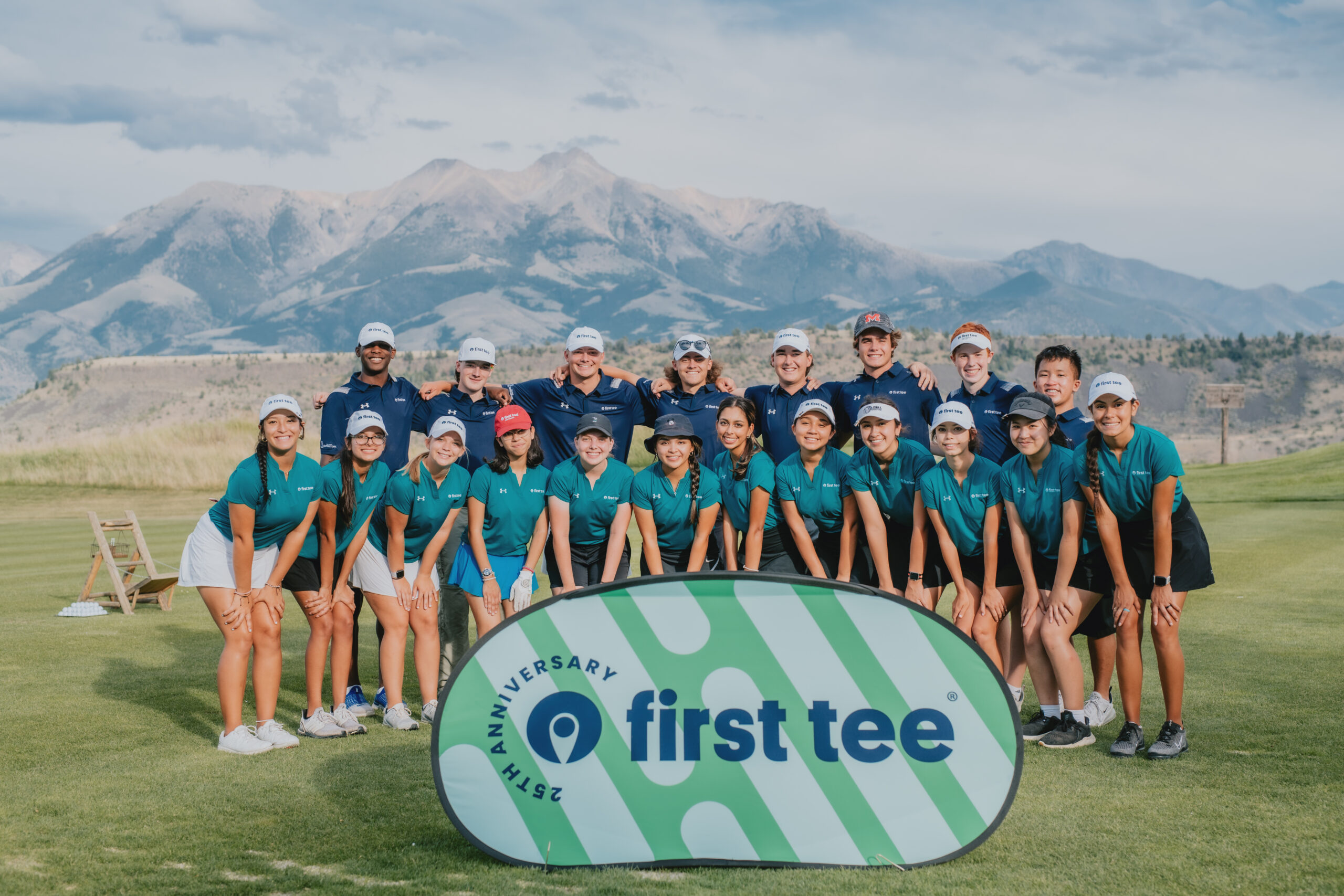 Group of First Tee participants posed in front of a mountain at the 2022 First Tee Leadership Summit.