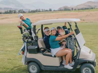 Group of First Tee participants on a golf cart.