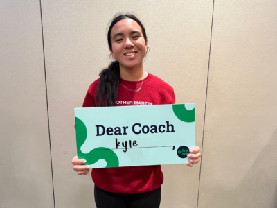 Participant holding Dear Coach sign