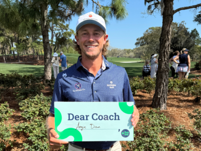 Holding Dear Coach sign