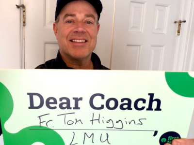 Holding Dear Coach sign