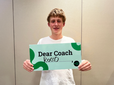 Participant holding Dear Coach sign