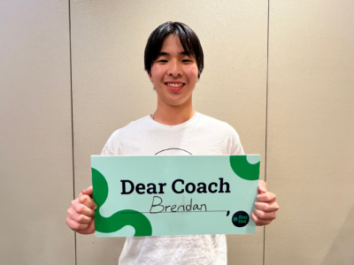 Participant holding Dear Coach sign