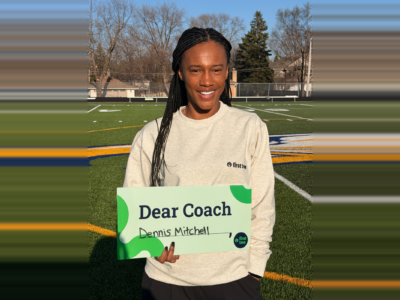 holding Dear Coach sign