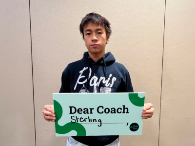 Participant holding Dear Coach sign