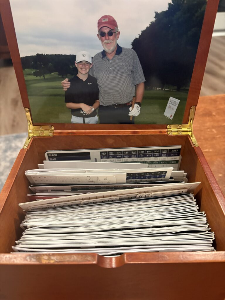 The box of scorecards Logan received from his grandfather, commemorating their time on the course